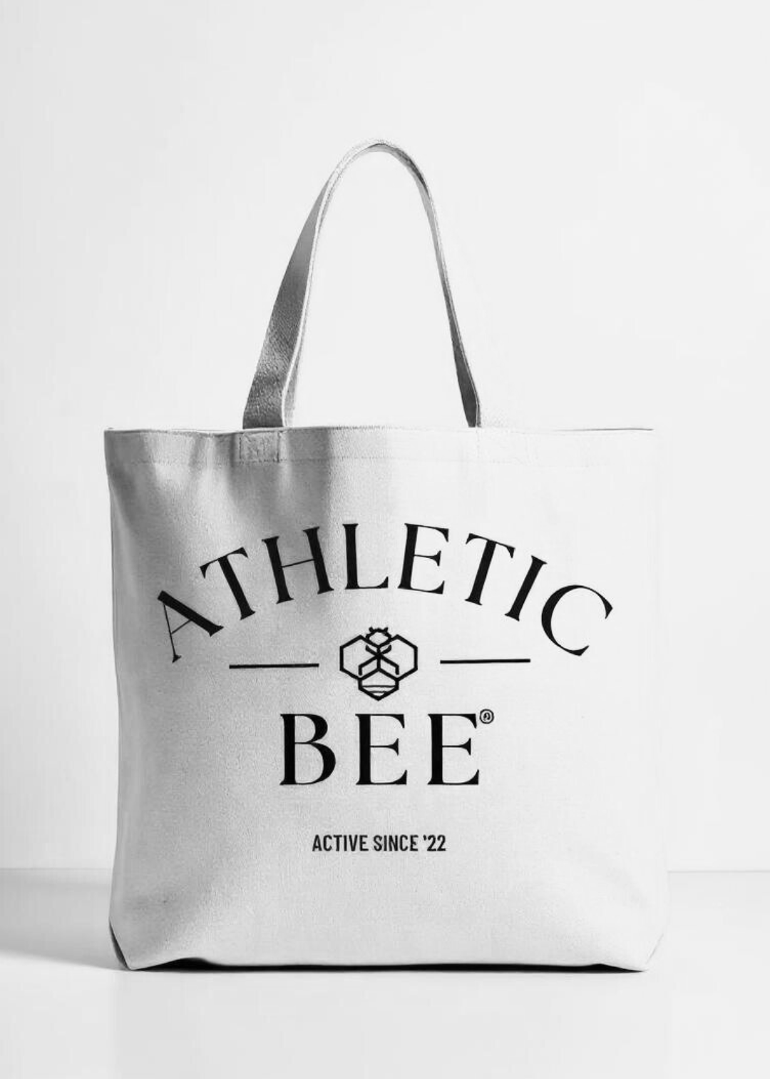 white tote bag with 'Athletic Bee' logo on a white background